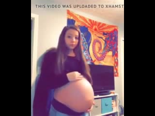 11286260 young pregnant teen shows belly